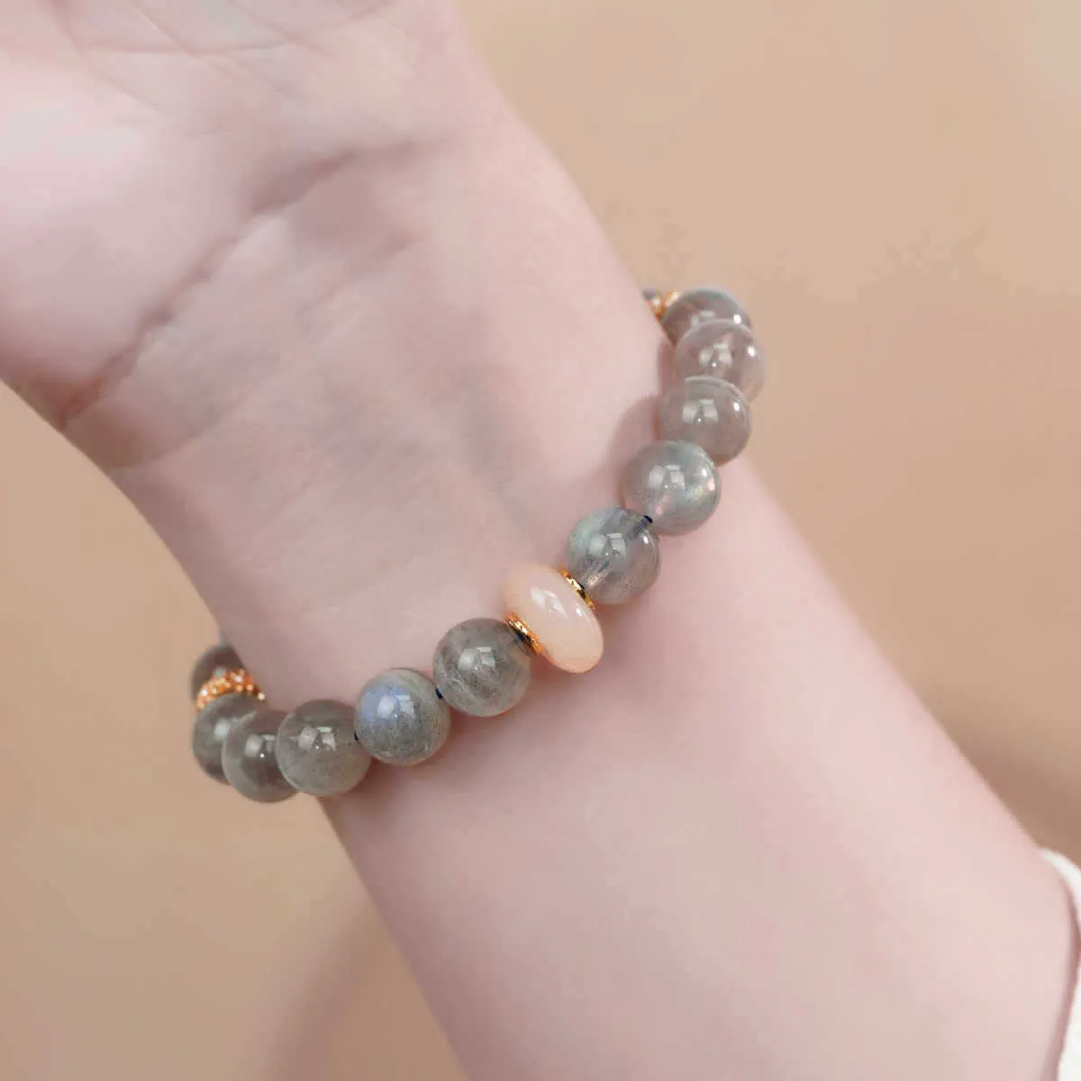 Handcrafted gray moonstone half bracelet for women with 8mm round agate beads on a wrist.