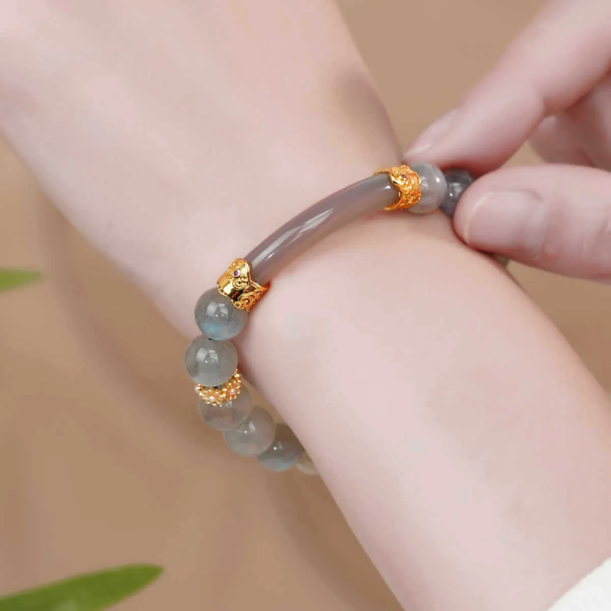 Handcrafted gray moonstone half bracelet for women with 8mm round agate beads on a wrist.
