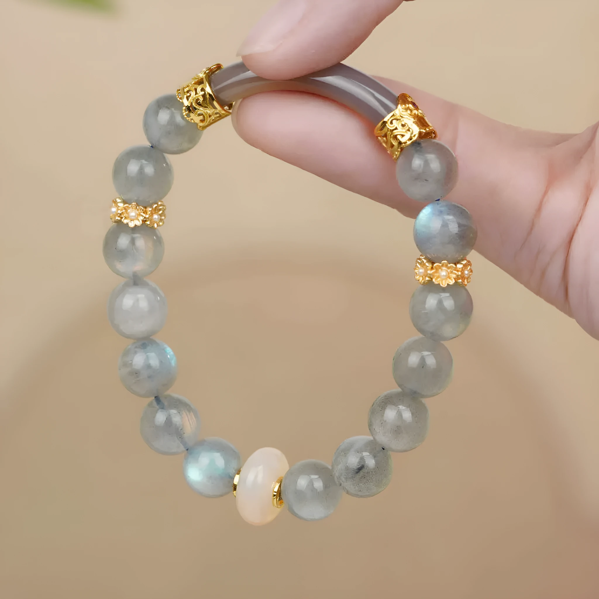 Handcrafted gray moonstone half bracelet for women with 8mm round agate beads on a wrist.