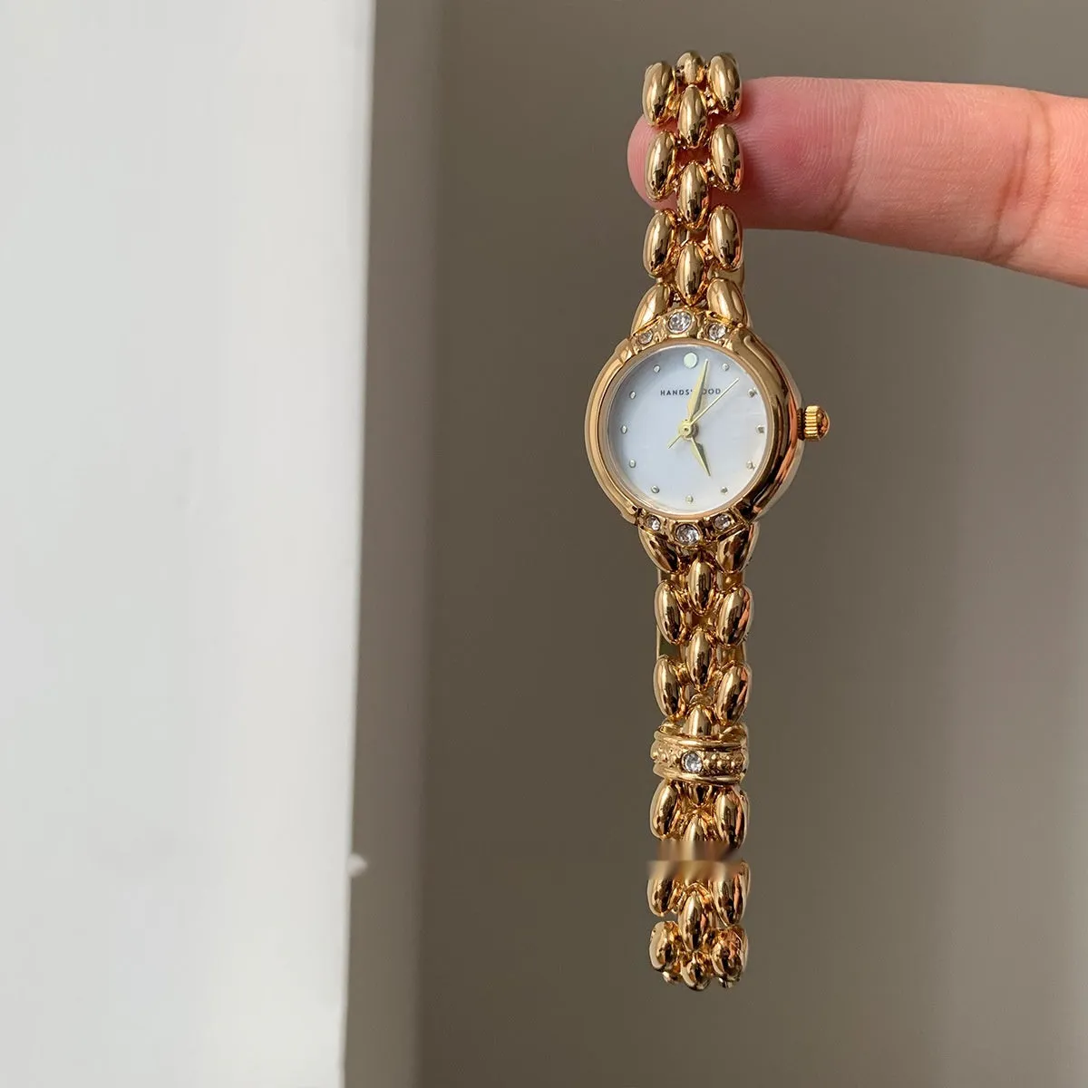 Women's alloy quartz watch with gold strap and rhinestone dial fritillary surface