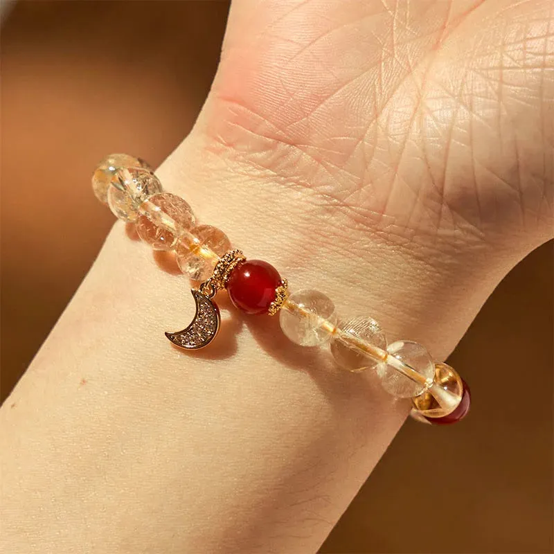 Women's crystal boom bracelet featuring citrine stone, red agate, and central moon design