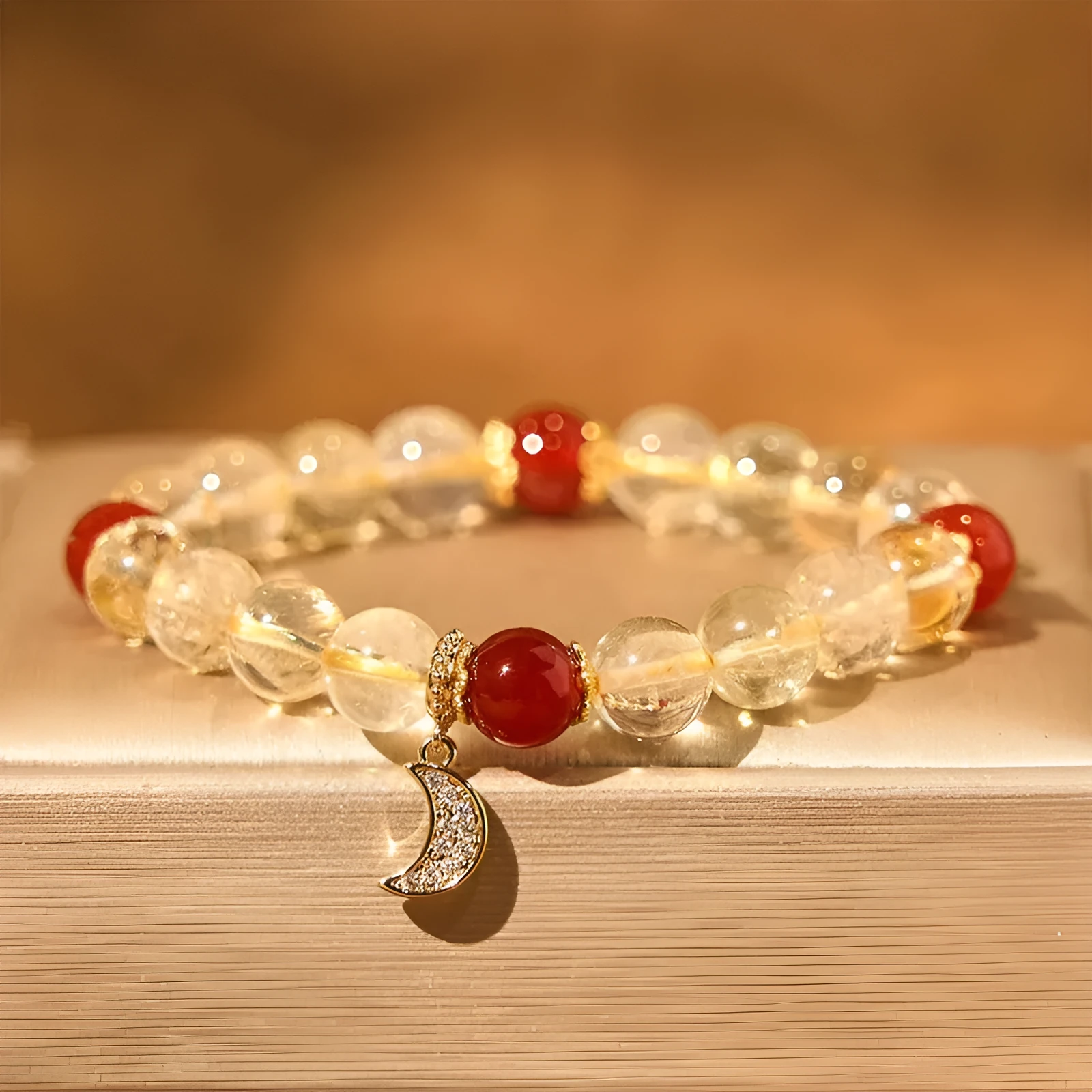 Women's crystal boom bracelet featuring citrine stone, red agate, and central moon design