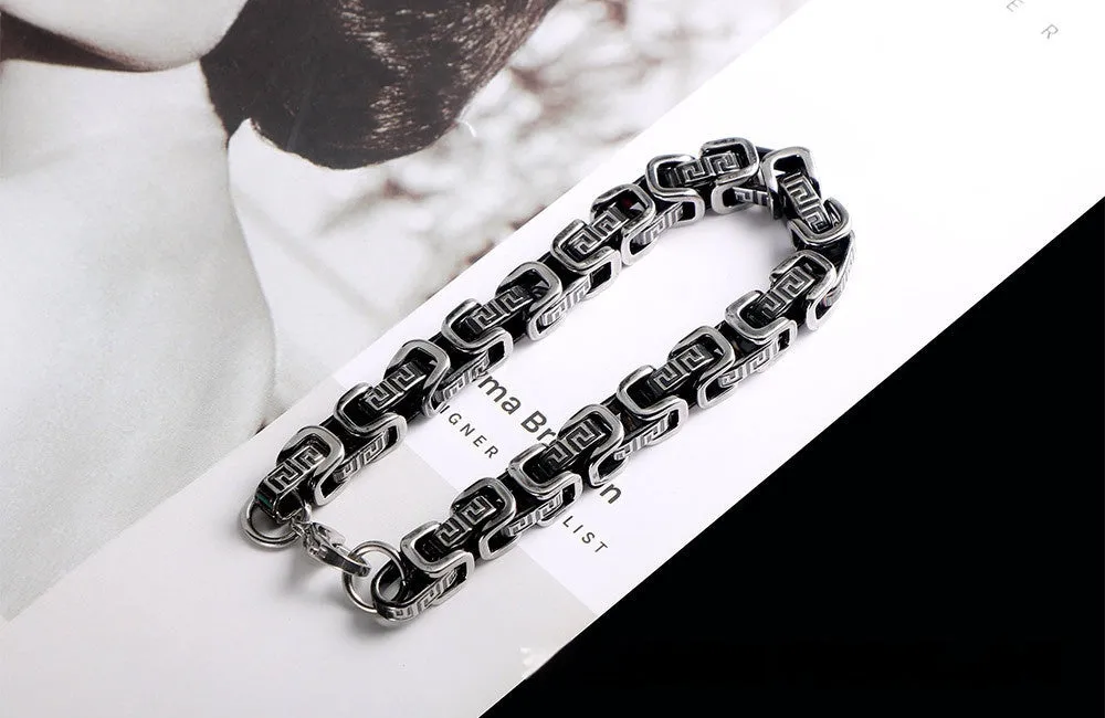 Retro black polished stainless steel geometric chain bracelet on a neutral surface