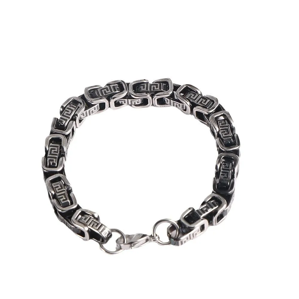 Retro black polished stainless steel geometric chain bracelet on a neutral surface