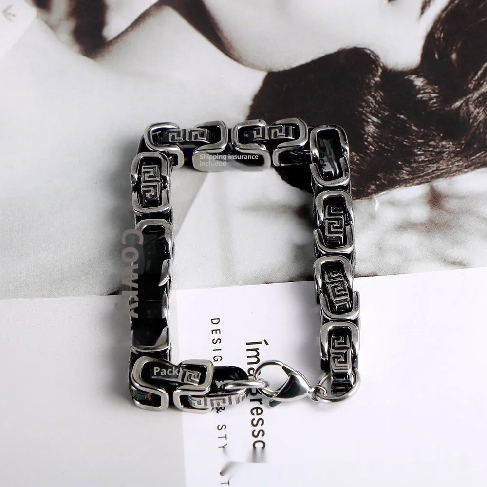Retro black polished stainless steel geometric chain bracelet on a neutral surface