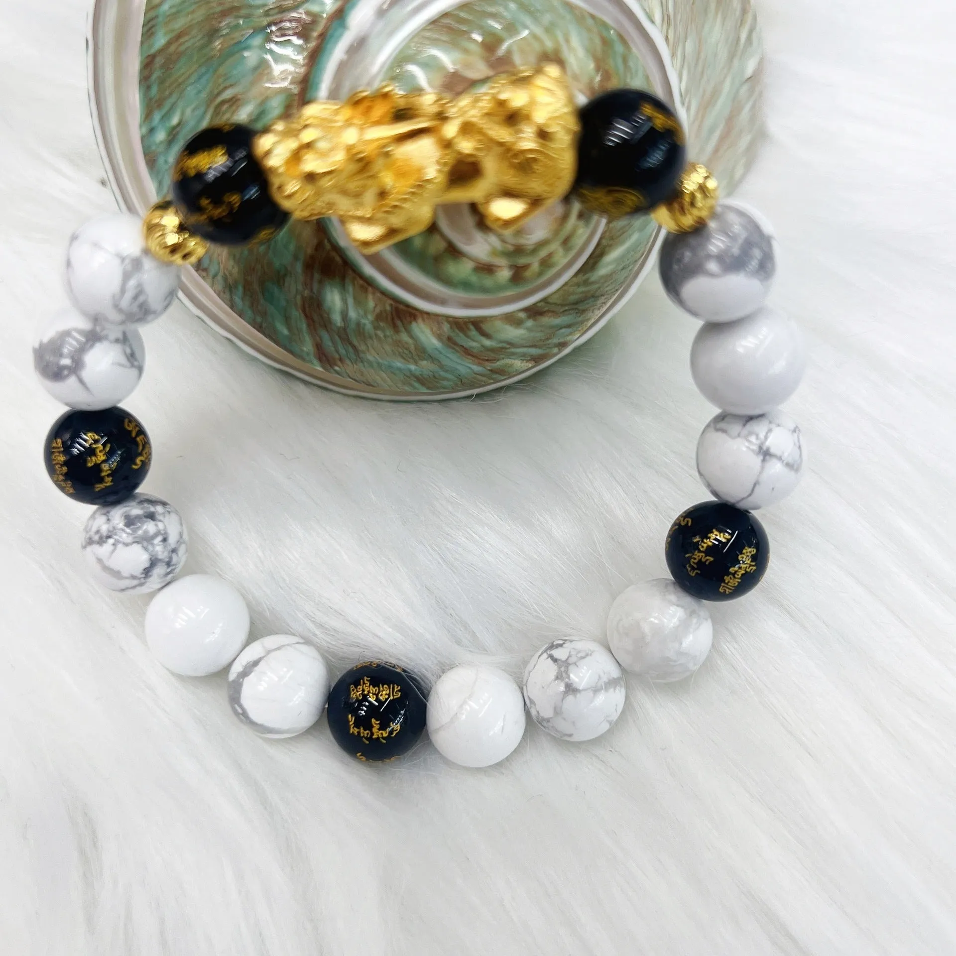 Vintage couple bracelet with white turquoise and black agate stones on a wrist.