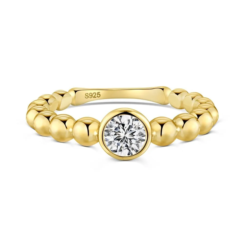 S925 sterling silver ring for women with gold wave bead design and geometric polka-dot pattern on white background