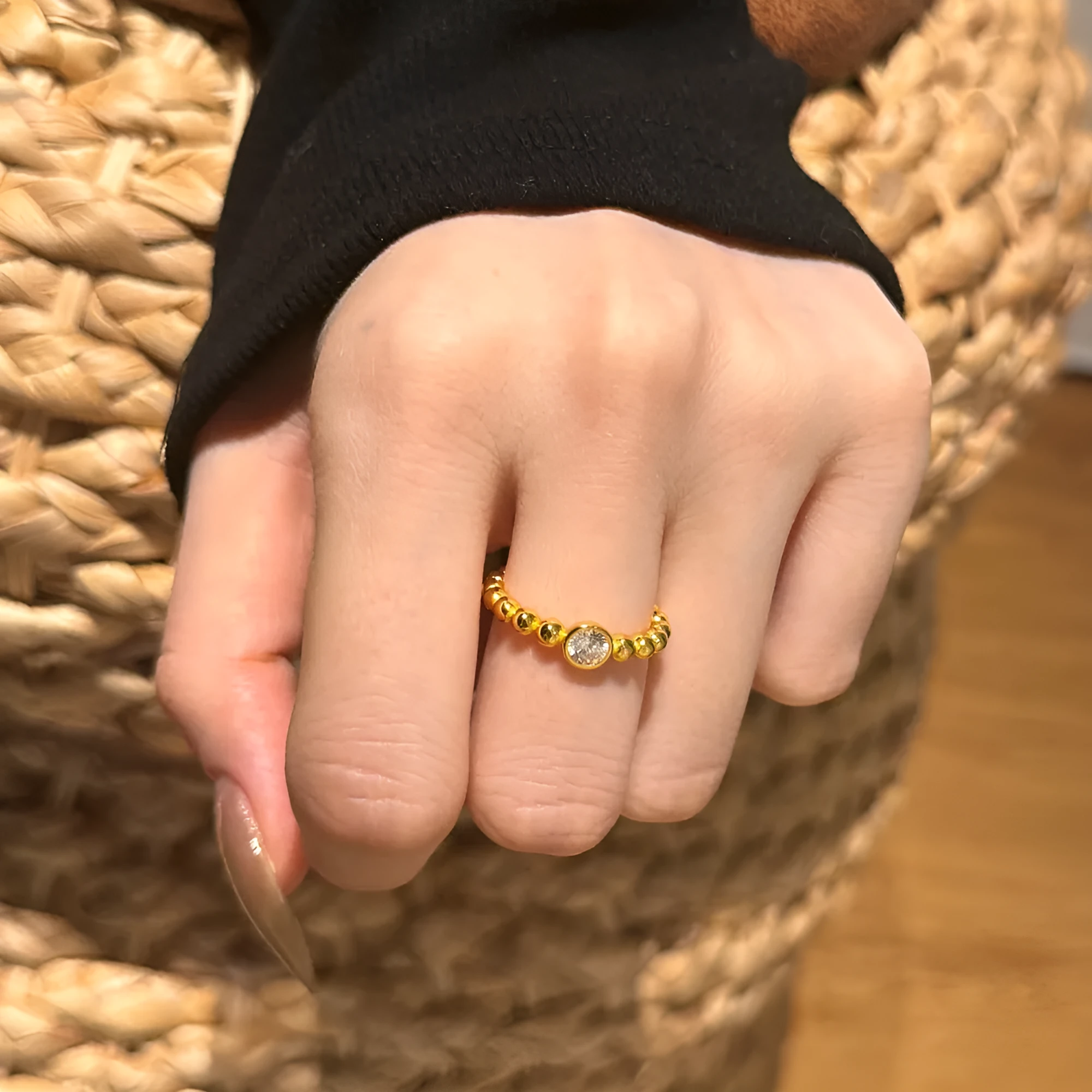 S925 sterling silver ring for women with gold wave bead design and geometric polka-dot pattern on white background