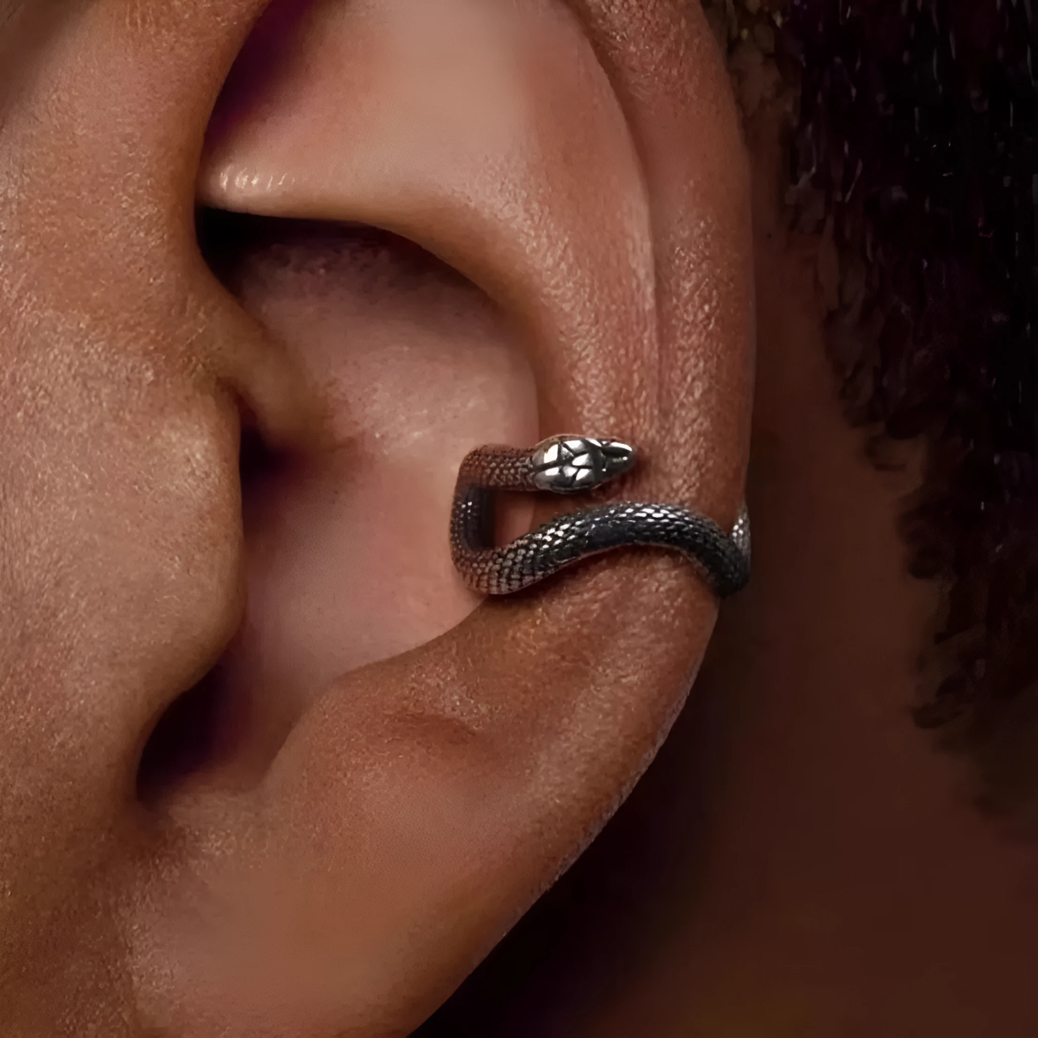 Retro snake-shaped alloy ear clip with electroplated finish on a neutral background