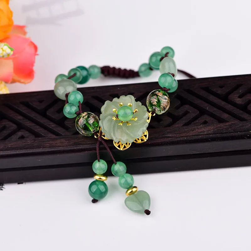 Women's hand-woven bracelet with Chinese auspicious patterns showing flower elements and mixed material texture