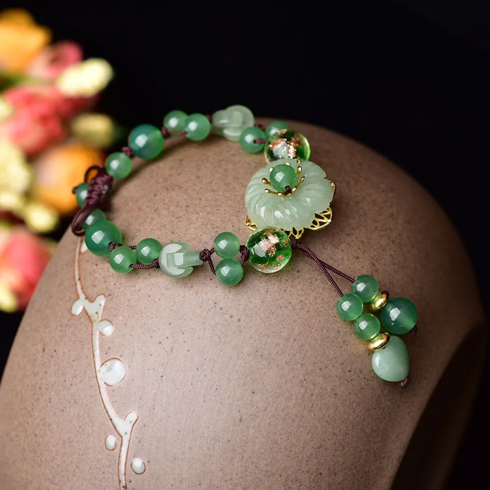 Women's hand-woven bracelet with Chinese auspicious patterns showing flower elements and mixed material texture