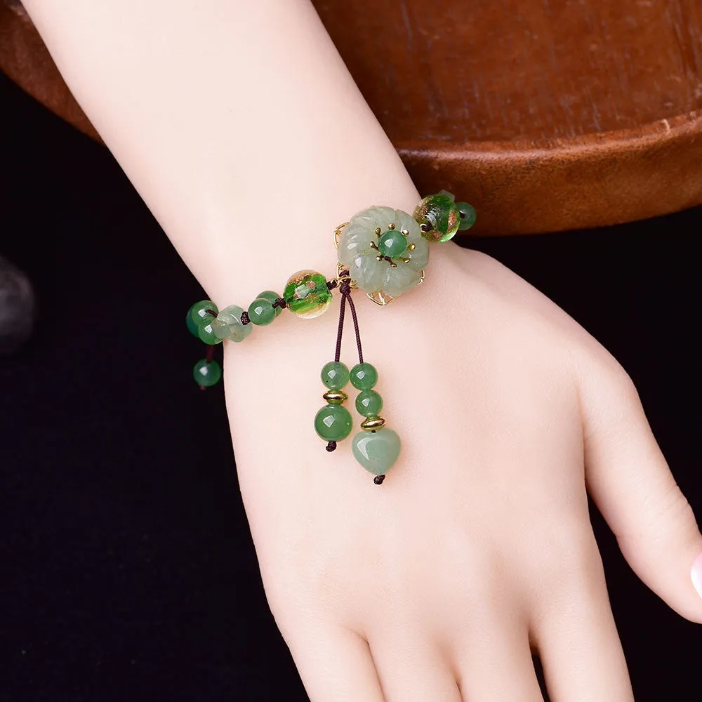 Women's hand-woven bracelet with Chinese auspicious patterns showing flower elements and mixed material texture