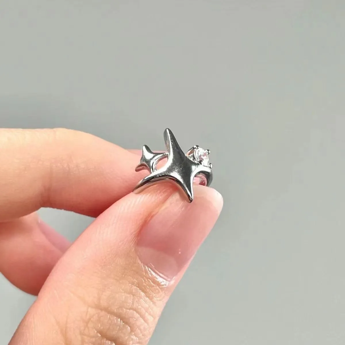 Women's retro geometric small diamond four eight-pointed stars ear clip in silver with electroplated finish