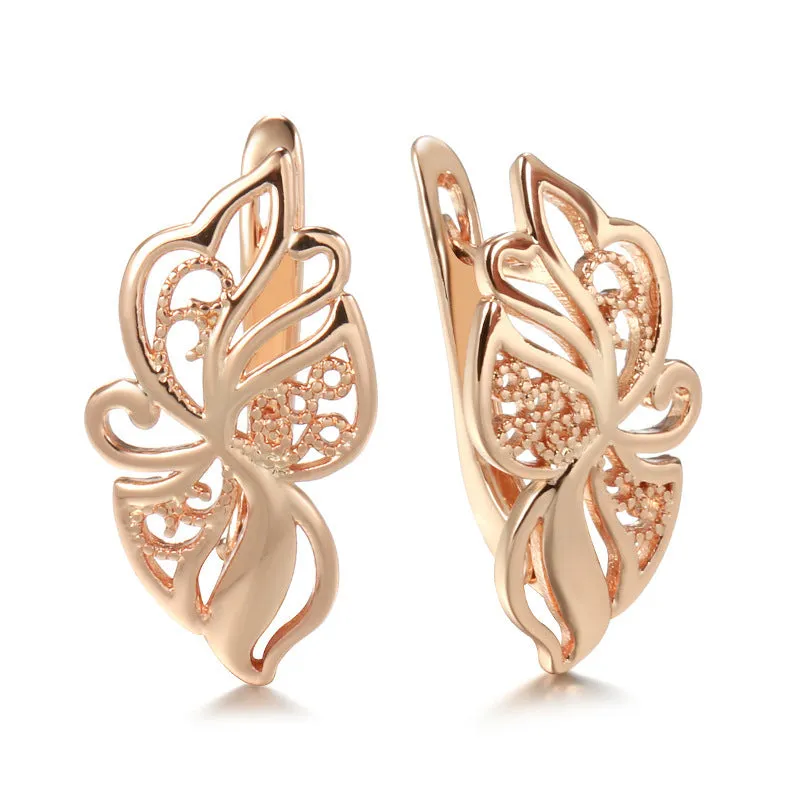 Women's rose gold earrings with hollow carved geometric design and rhinestone accents