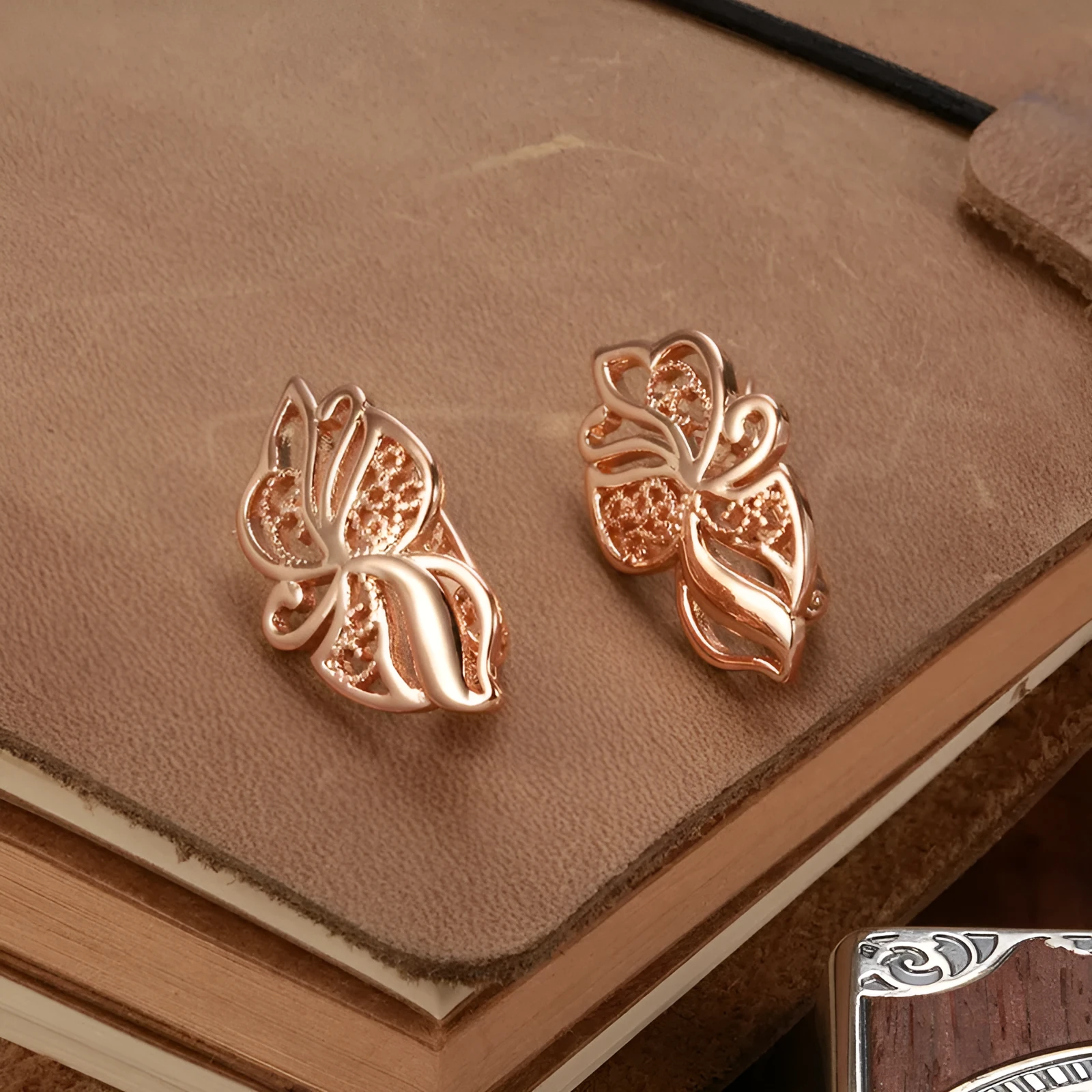 Women's rose gold earrings with hollow carved geometric design and rhinestone accents