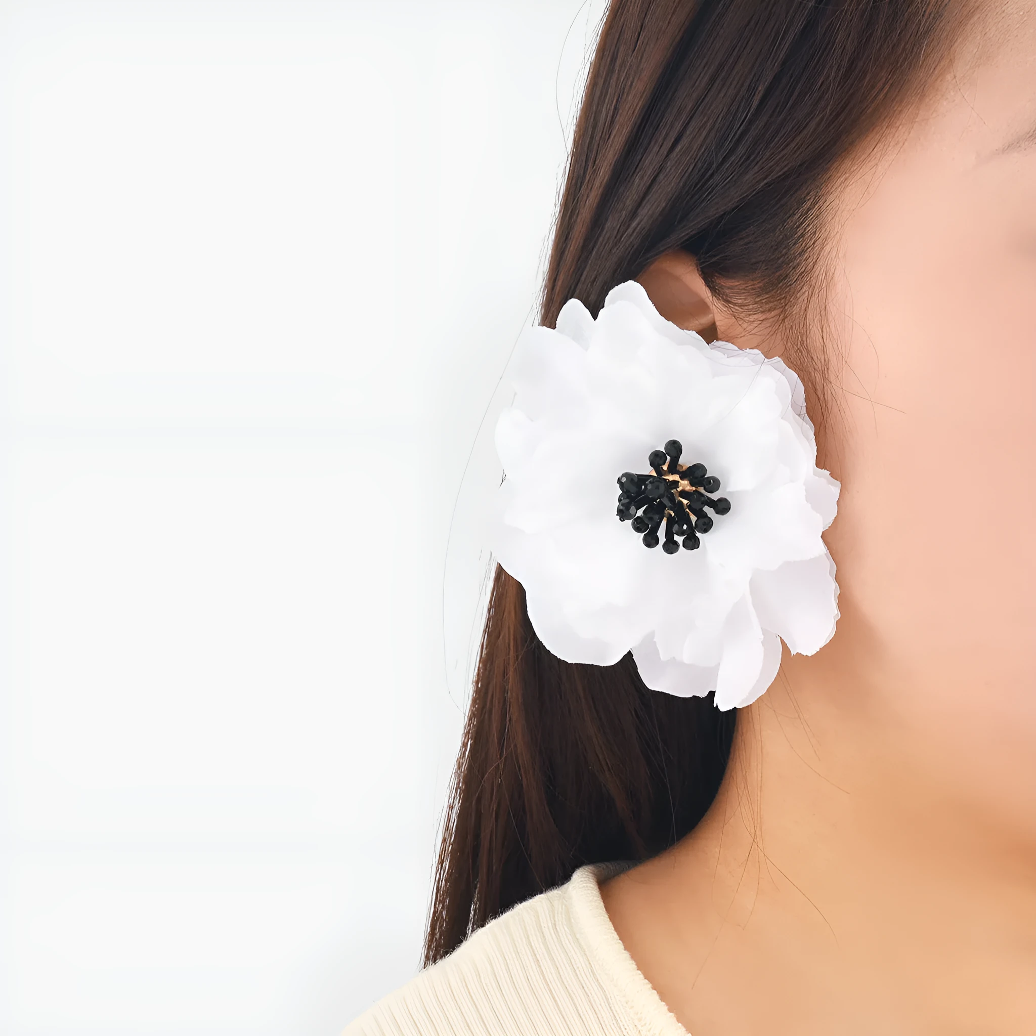 Hand-woven white plastic resin flower earrings for women fashion OL style on display