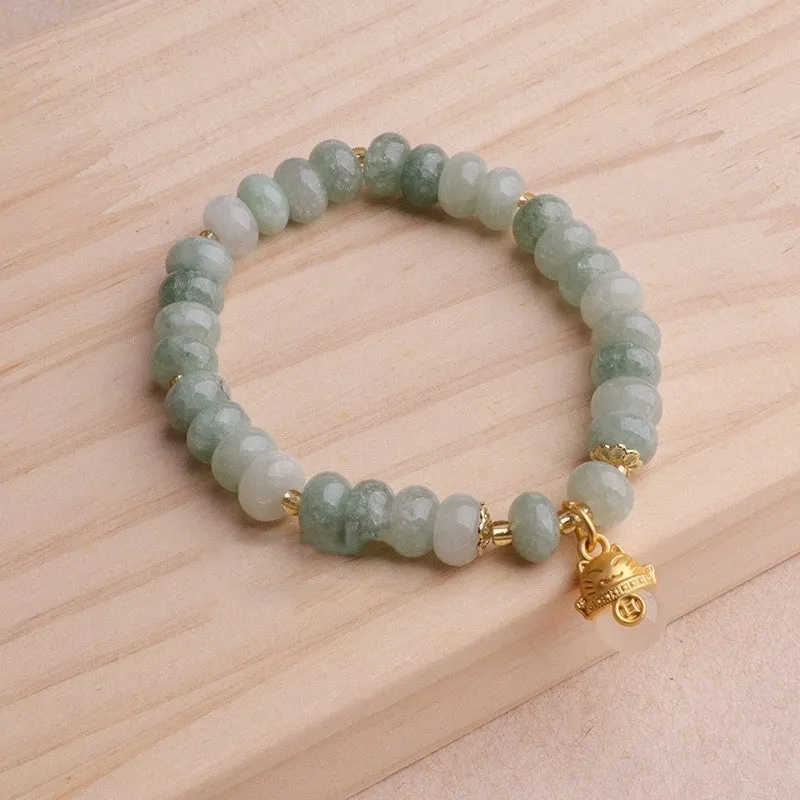 Women's retro strawberry quartz bracelet with lucky cat charm on wrist