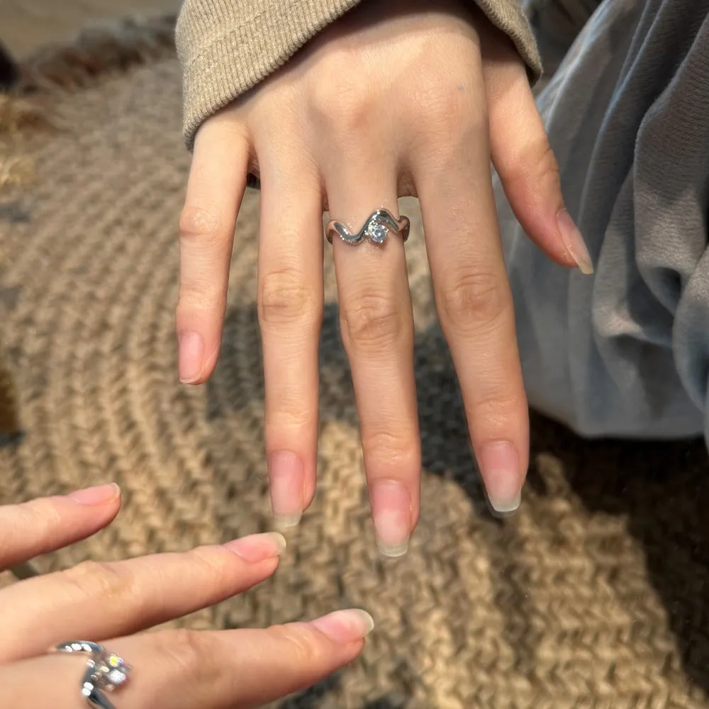 Women's silver electroplated open ring with single diamond and smooth wave line design, white gold tone