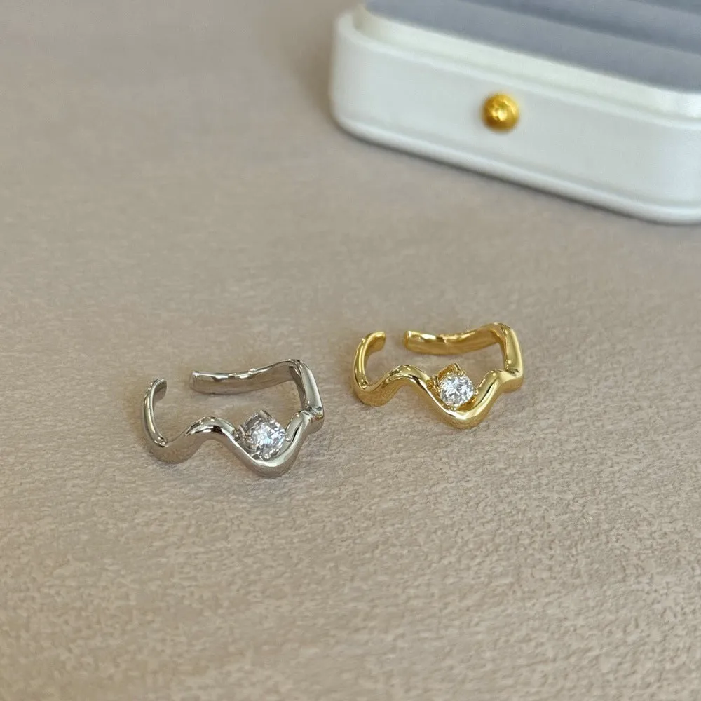 Women's silver electroplated open ring with single diamond and smooth wave line design, white gold tone