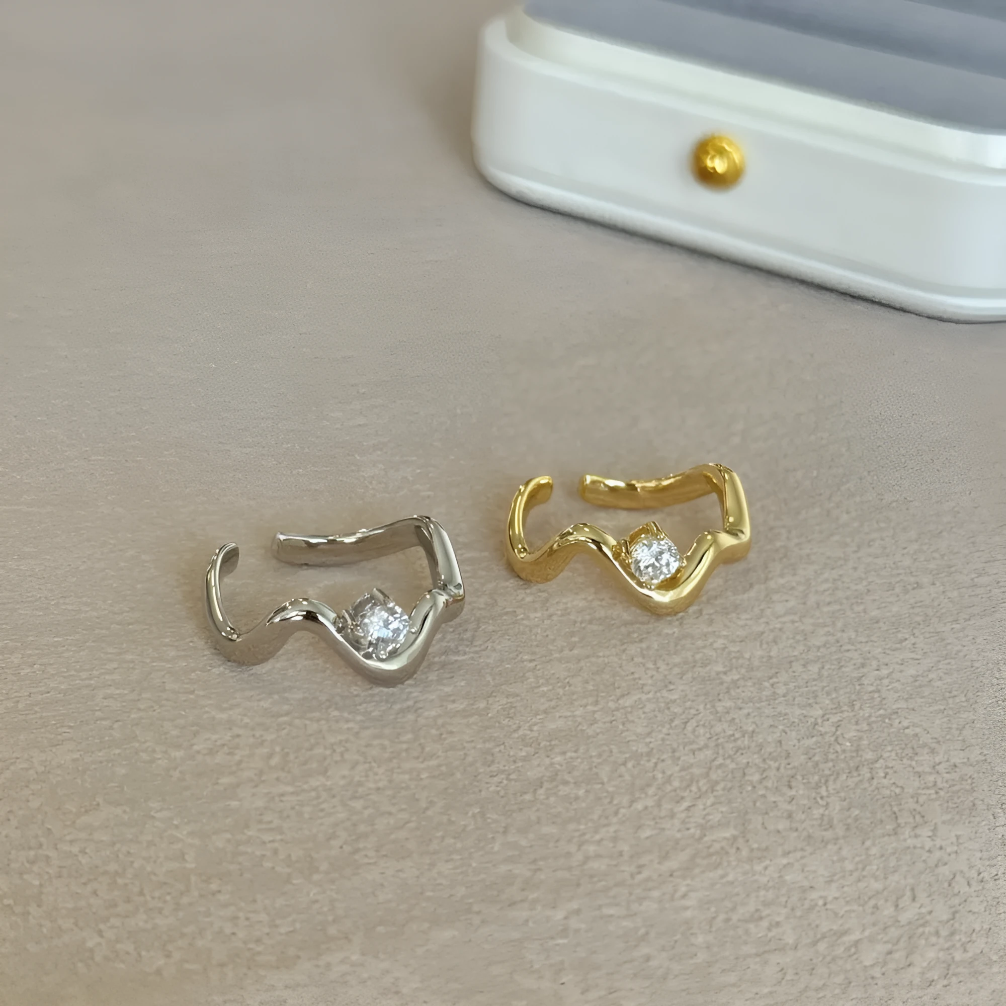 Women's silver electroplated open ring with single diamond and smooth wave line design, white gold tone