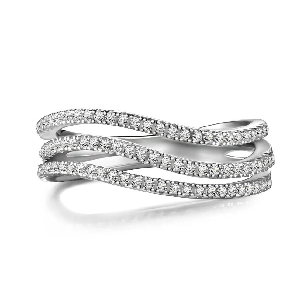 Silver ring with round zircon inlay, platinum colour, sits on a flat surface, side view