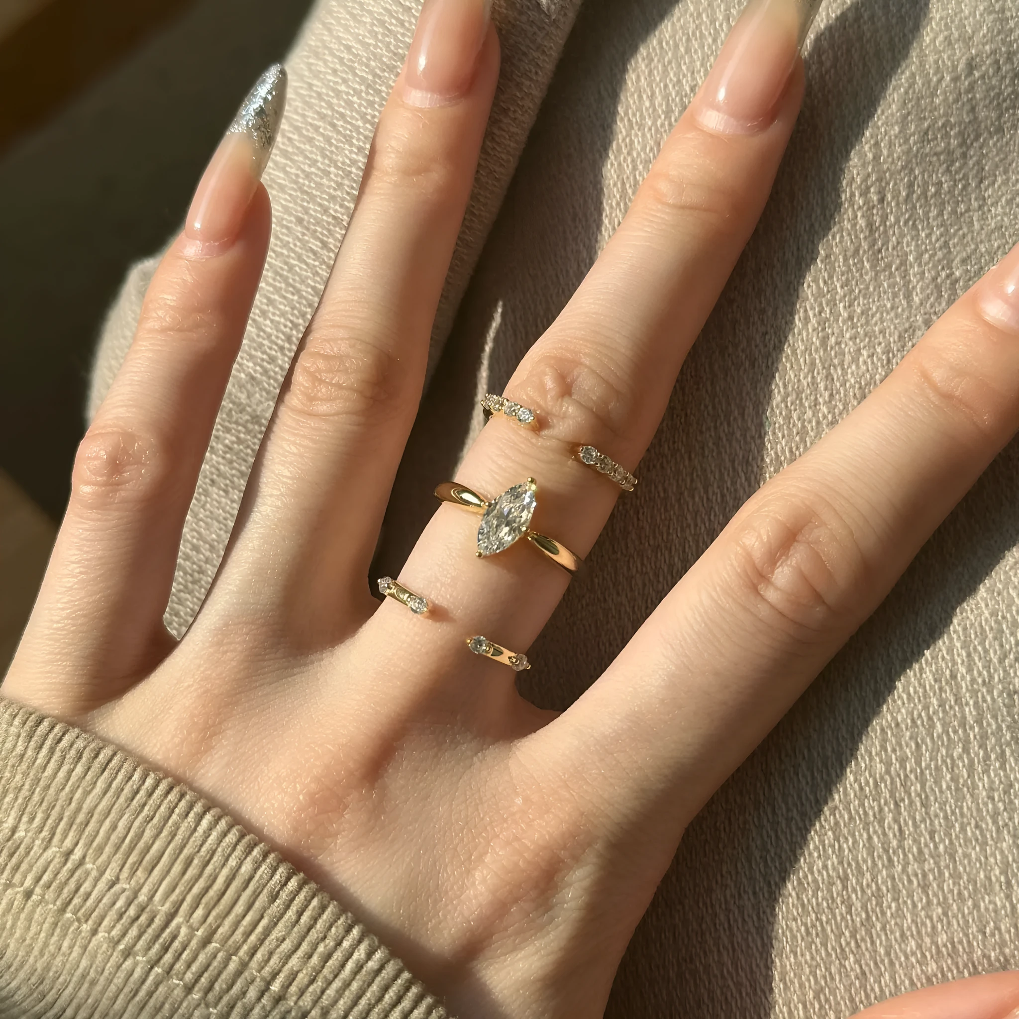 Sterling silver open ring with irregular wave design and adjustable opening on female hand
