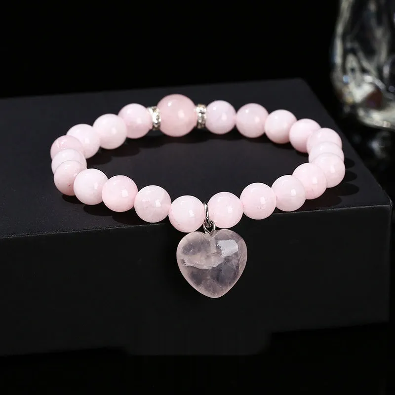 Natural stone love heart pendant bracelet on wrist, showing Tigereye, crystal or aventurine beads.