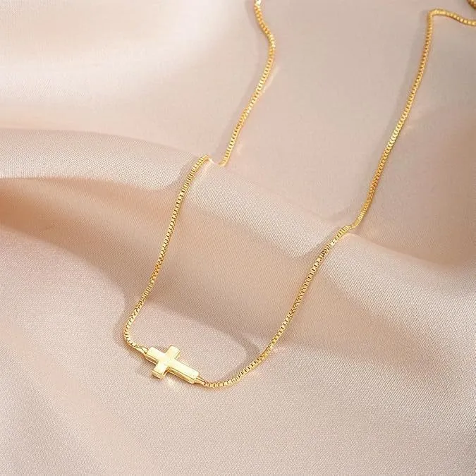 Miniature cross pendant necklace for women in alloy, dainty style on display