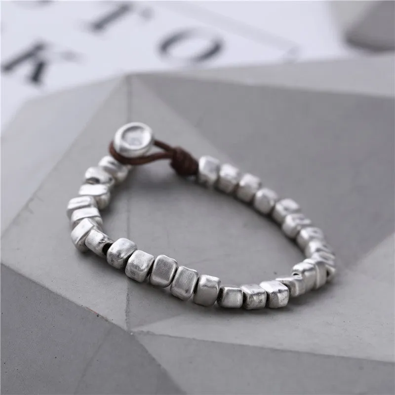 Women's handmade silver bracelet with wooden irregular square design on elasticated band