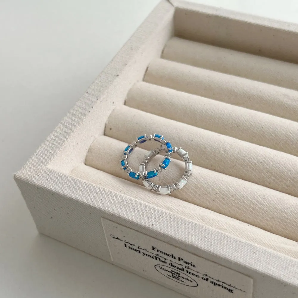 S925 sterling silver U-shaped opal ring with electroplated finish in opal blue, side view on white background