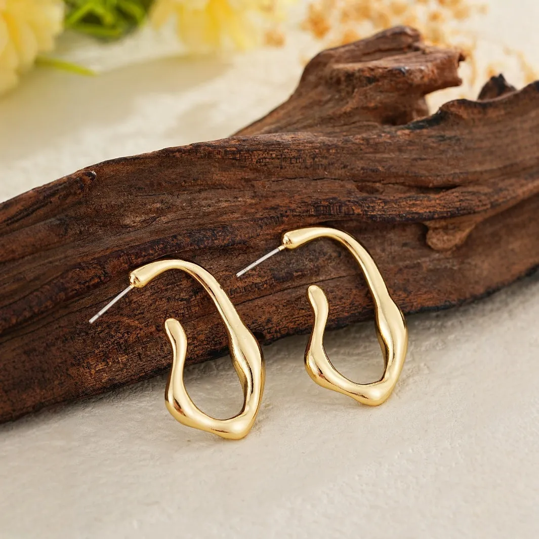 Irregular shaped minimalist gold dangle earrings for women on white background