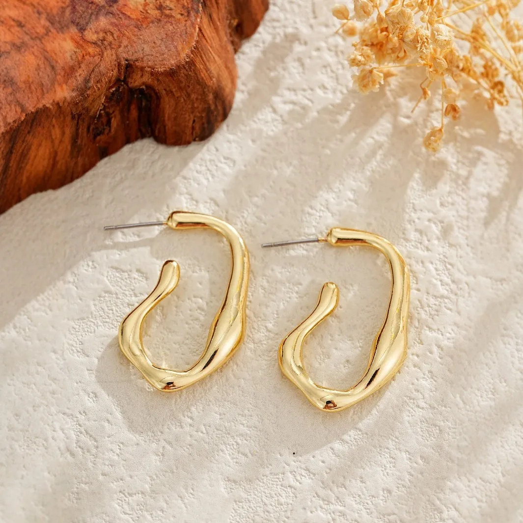 Irregular shaped minimalist gold dangle earrings for women on white background