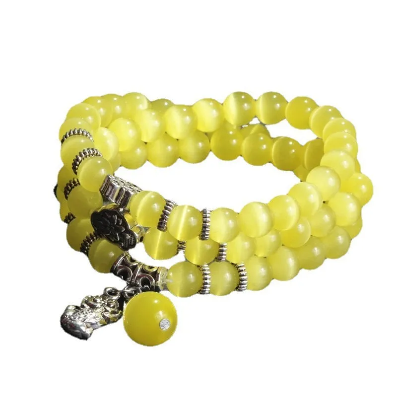 Opal cat eye bracelet with three geometric rings and lucky cat charms on adjustable 52cm cord