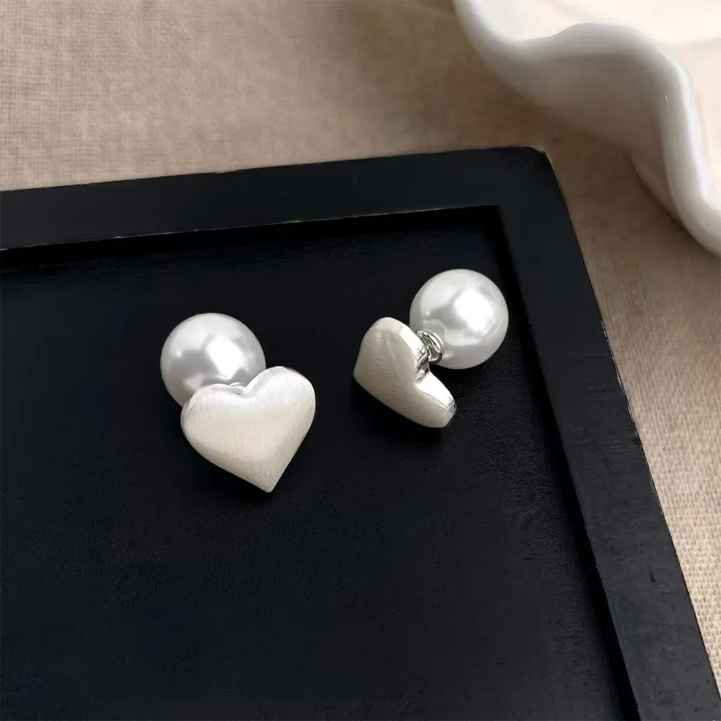 Love Pearl women's white pearl stud earrings 10mm with push-back backing on neutral background