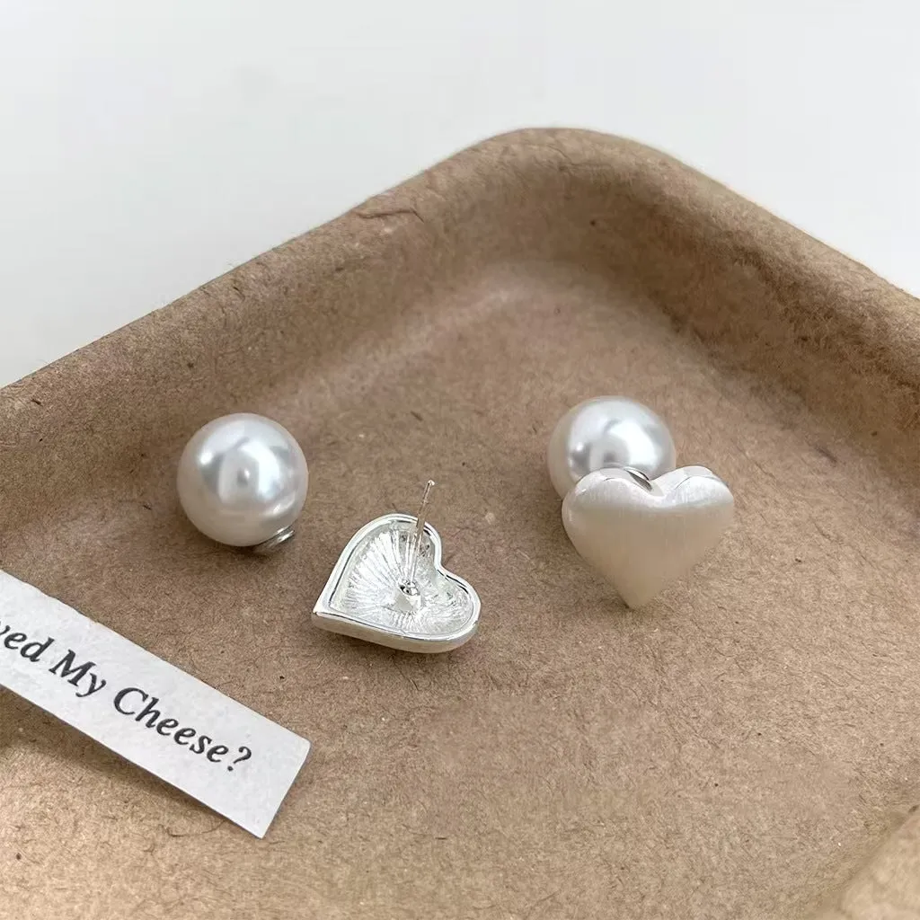Love Pearl women's white pearl stud earrings 10mm with push-back backing on neutral background