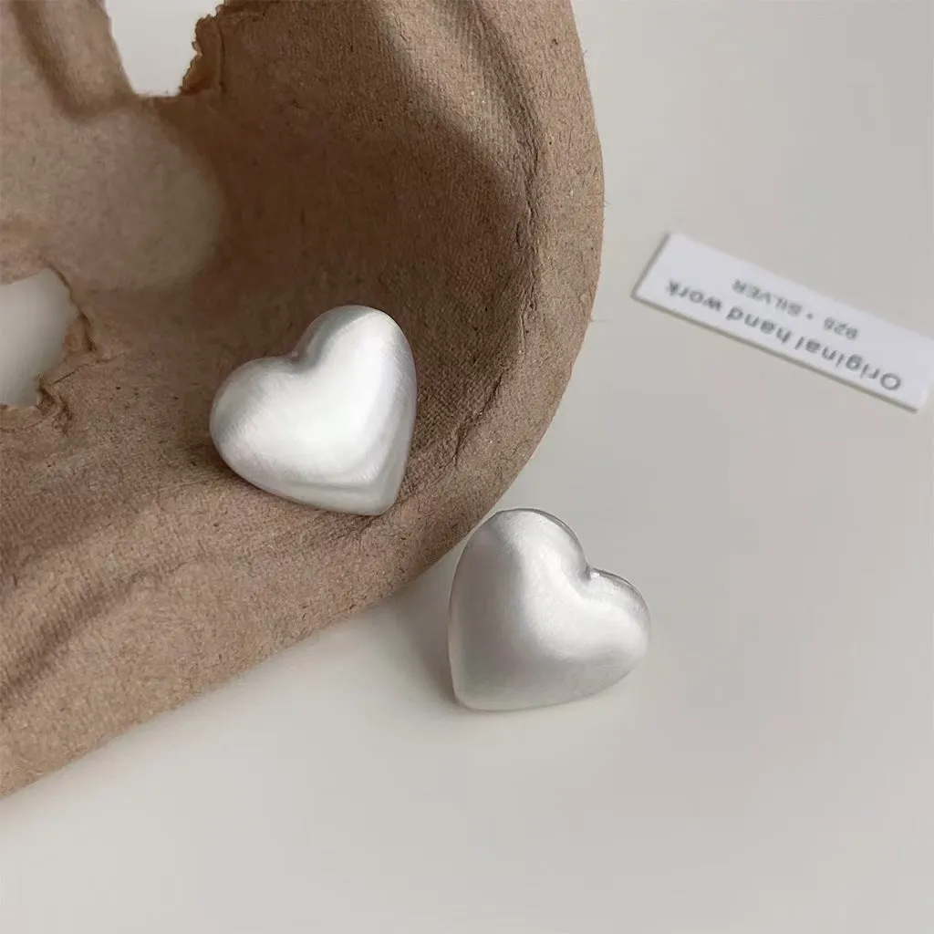 Love Pearl women's white pearl stud earrings 10mm with push-back backing on neutral background