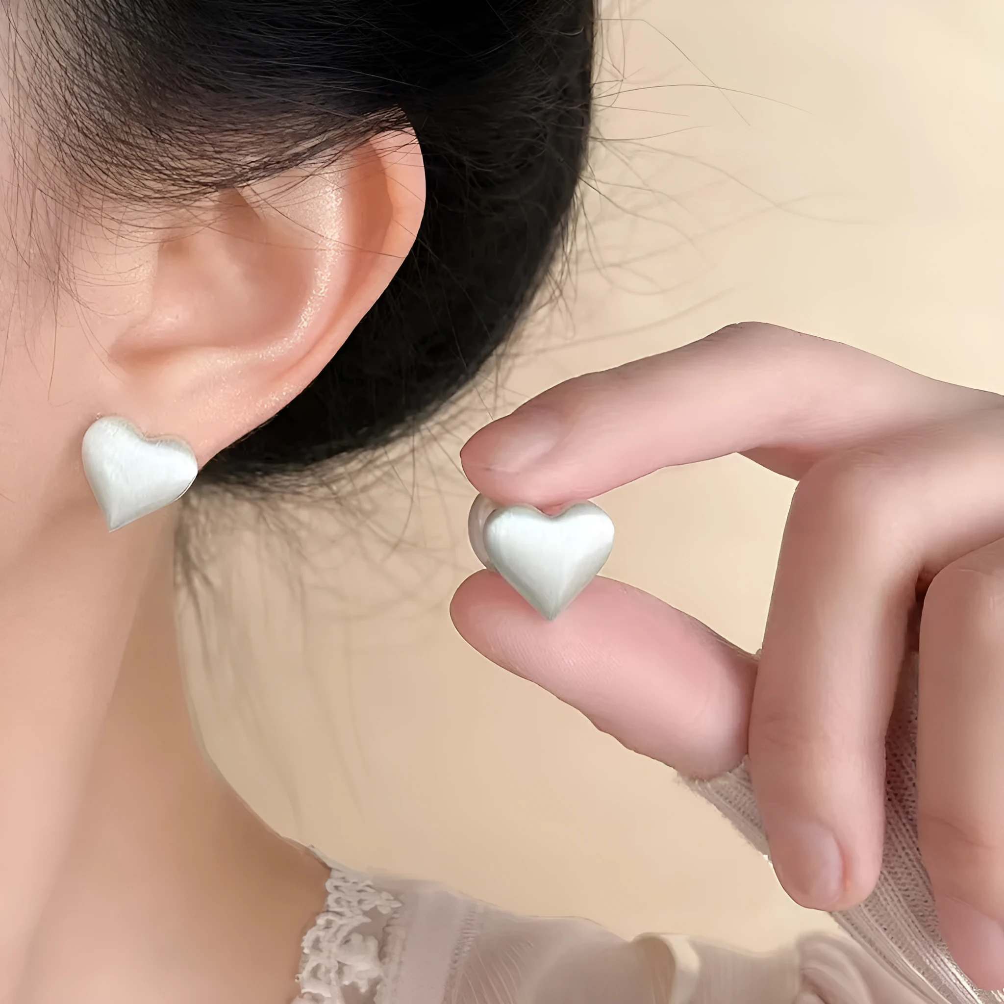 Love Pearl women's white pearl stud earrings 10mm with push-back backing on neutral background
