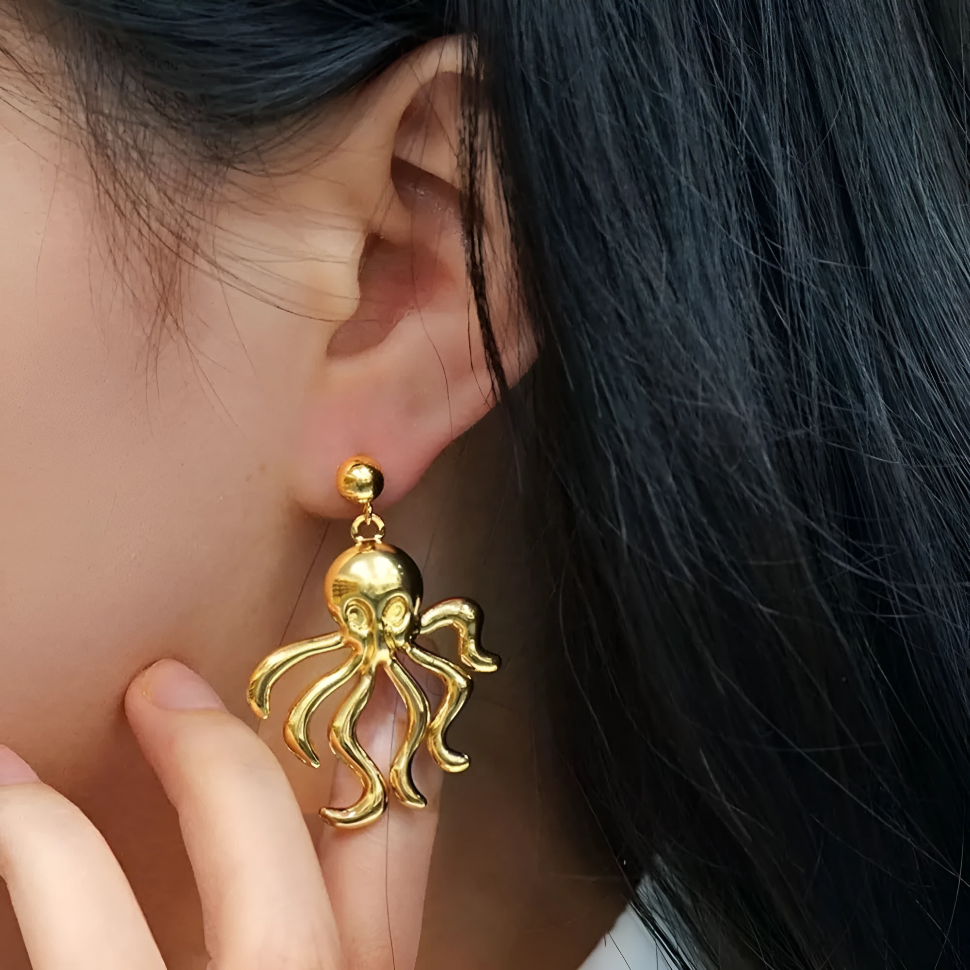 Gold octopus stud earrings made of stainless steel in minimalist retro style