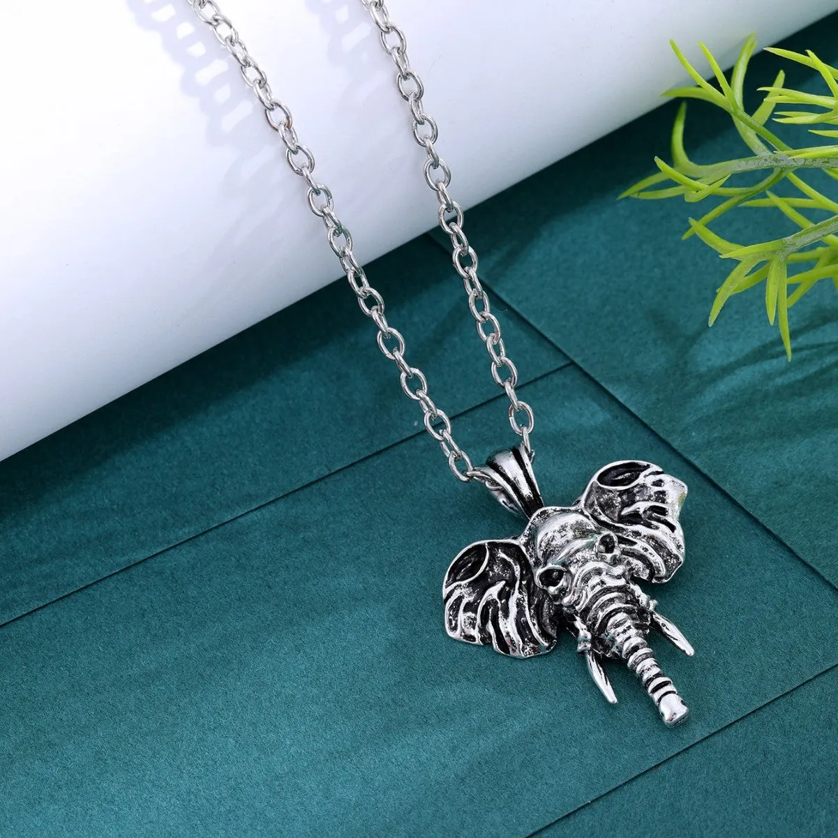 Silver and black elephant god pendant necklace on display, stainless steel construction for men.