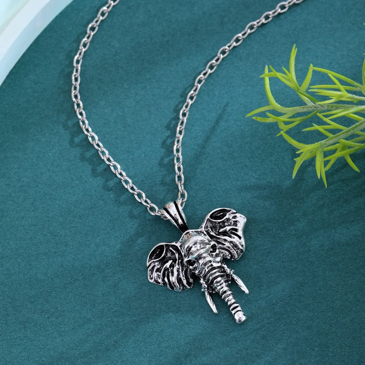 Silver and black elephant god pendant necklace on display, stainless steel construction for men.