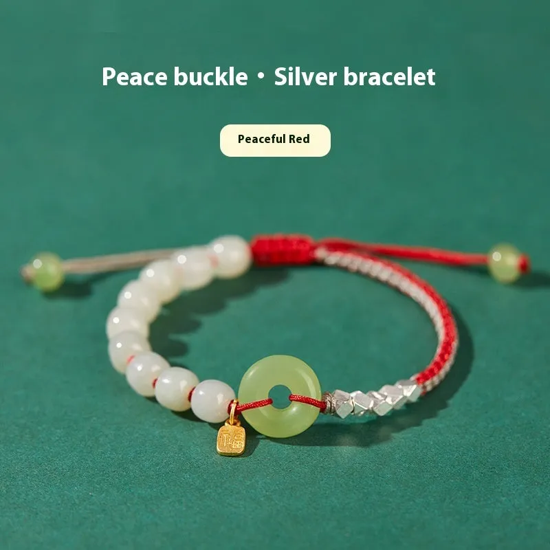 Woven bracelet with a natural Hetian jade flower charm and safety buckle in maple leaf yellow.