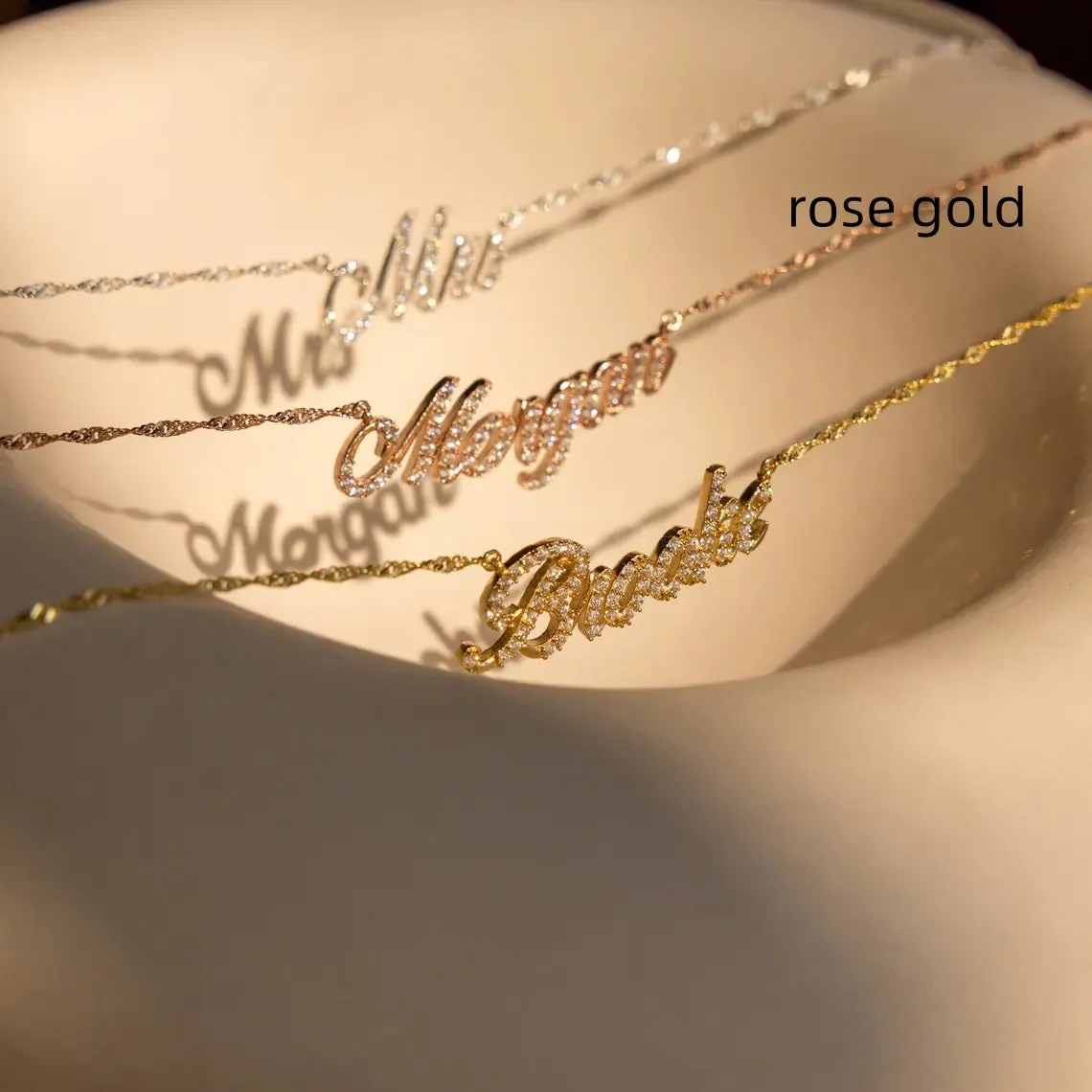 Customised copper geometric name necklace for women in gold finish on white background