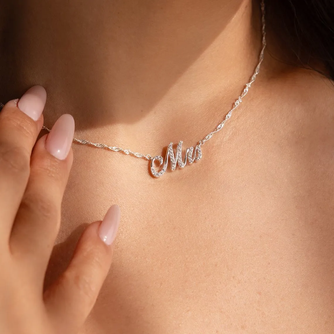 Customised copper geometric name necklace for women in gold finish on white background