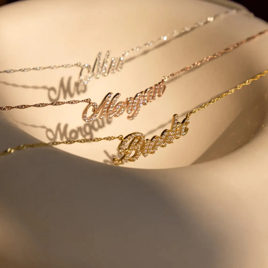 Customised copper geometric name necklace for women in gold finish on white background