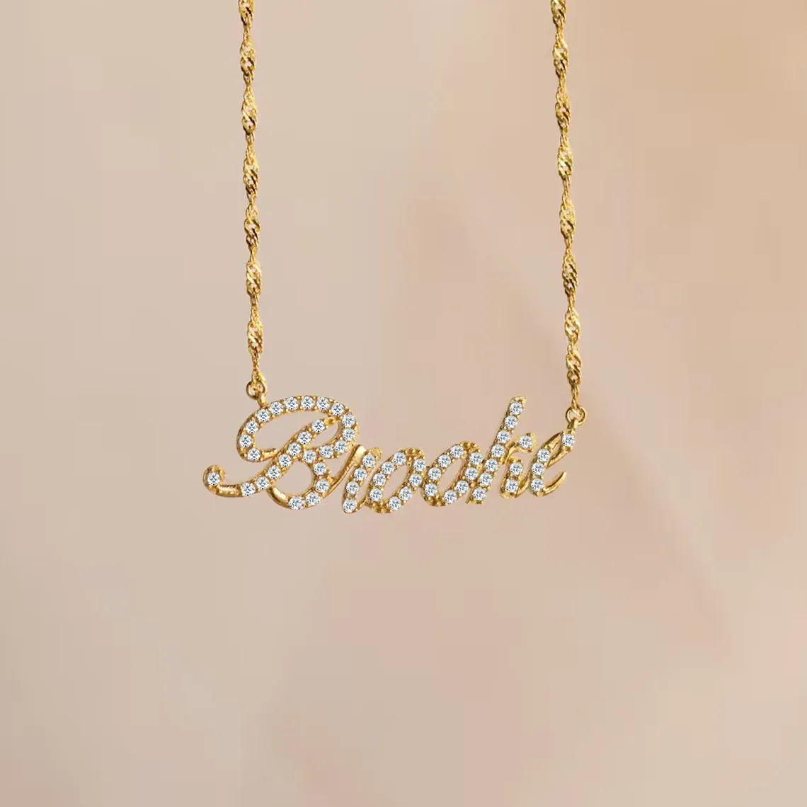 Customised copper geometric name necklace for women in gold finish on white background