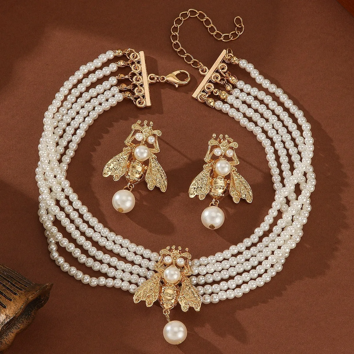Golden bee earrings and necklace set on display with alloy pendant and regular chain