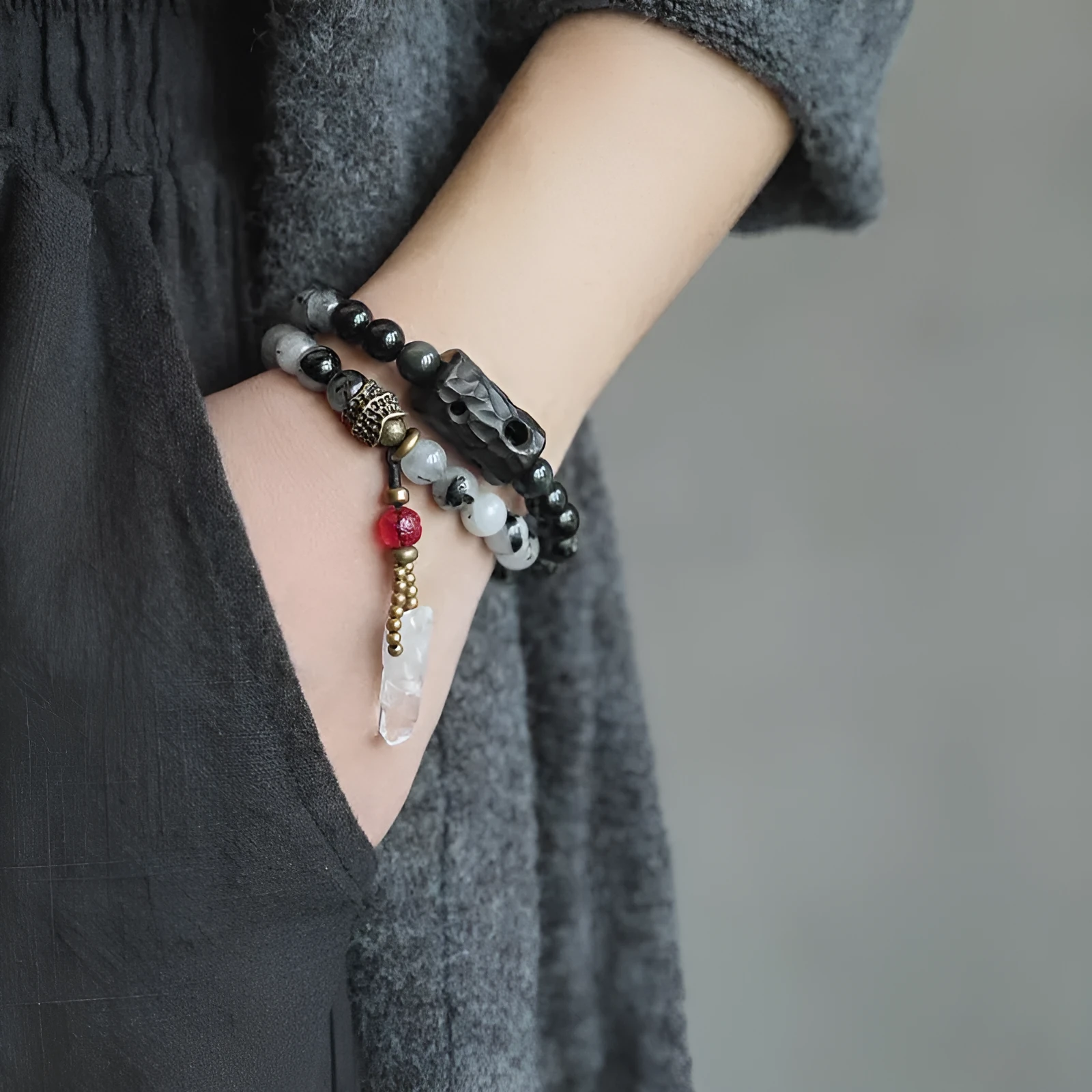 Ethnic style black hair crystal bracelet with white crystal tassel decoration showing bending and lacing construction