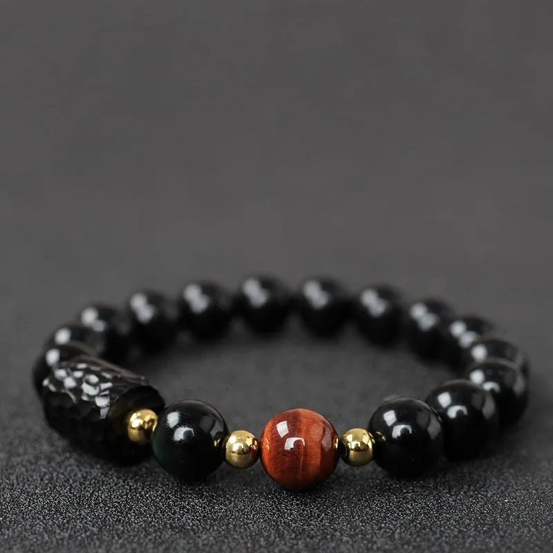 Handcrafted obsidian bracelet with 10mm yellow tiger eye beads on elastic cord