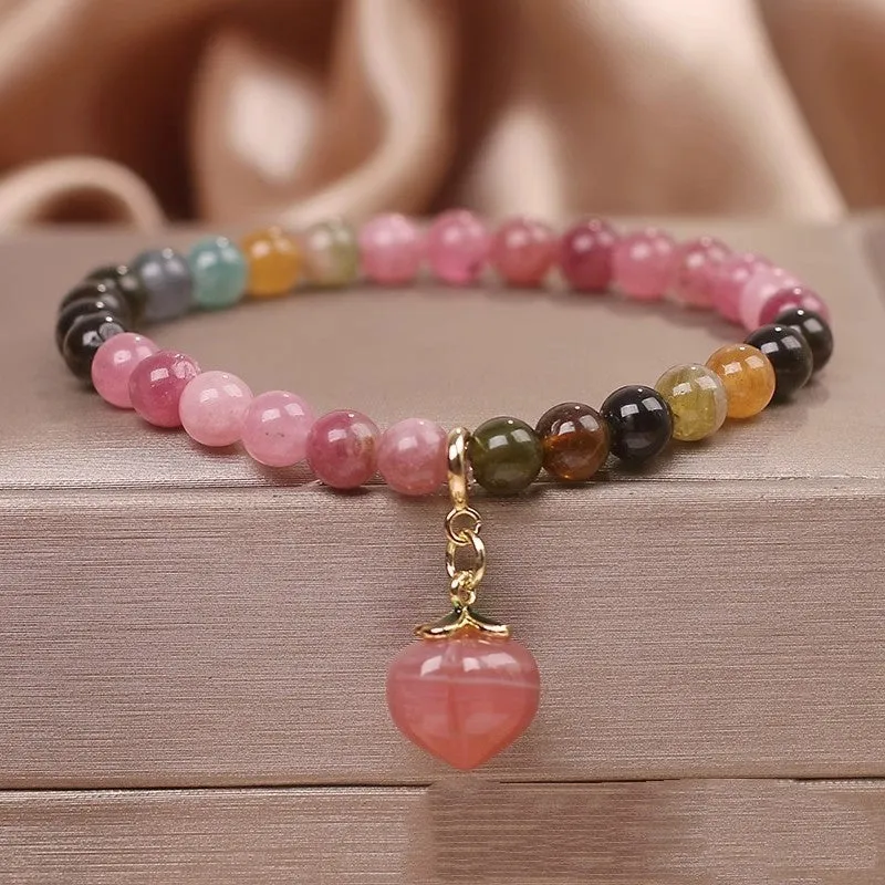 Natural rainbow tourmaline single-circle bracelet with agate peach pendant on wrist