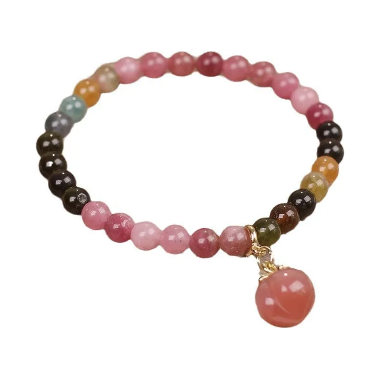 Natural rainbow tourmaline single-circle bracelet with agate peach pendant on wrist